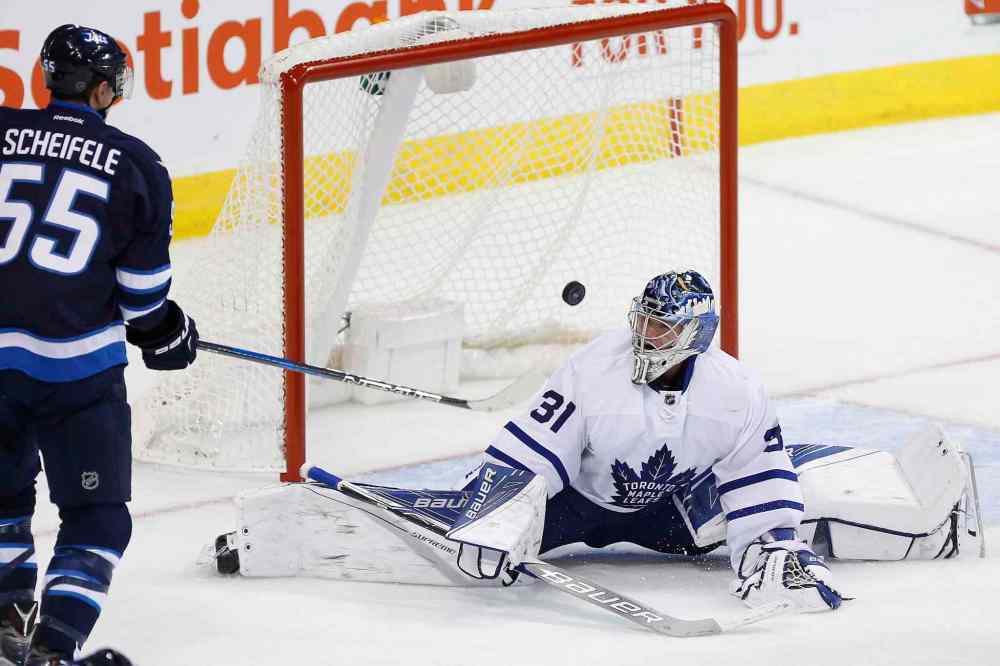 JOHN WOODS / THE CANADIAN PRESS
Winnipeg Jets' Mark Scheifele (55) looks on as Patrik Laine's (29) game tying goal goes past Toronto Maple Leafs goaltender Frederik Andersen (31) during third period NHL action in Winnipeg on Wednesday, October 19, 2016.