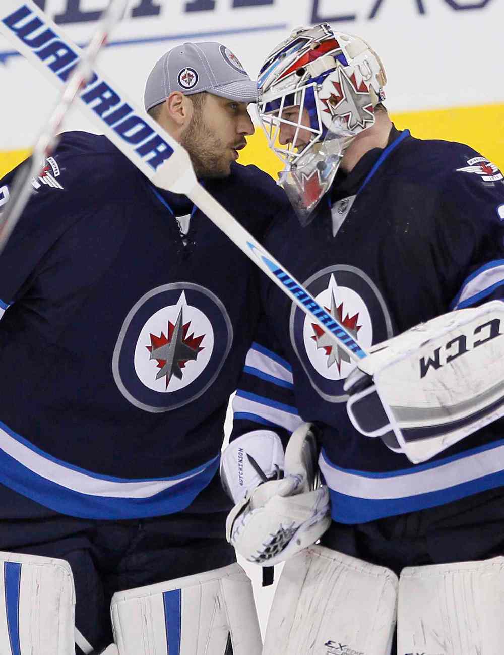 John Woods / The Canadian Press
Winnipeg Jets goaltender Michael Hutchinson (34) celebrates his first win in NHL win with Ondrej Pavelec (31) after making the big save on Boston Bruins' Brad Marchand (63) during the shoot out in Winnipeg on Thursday.