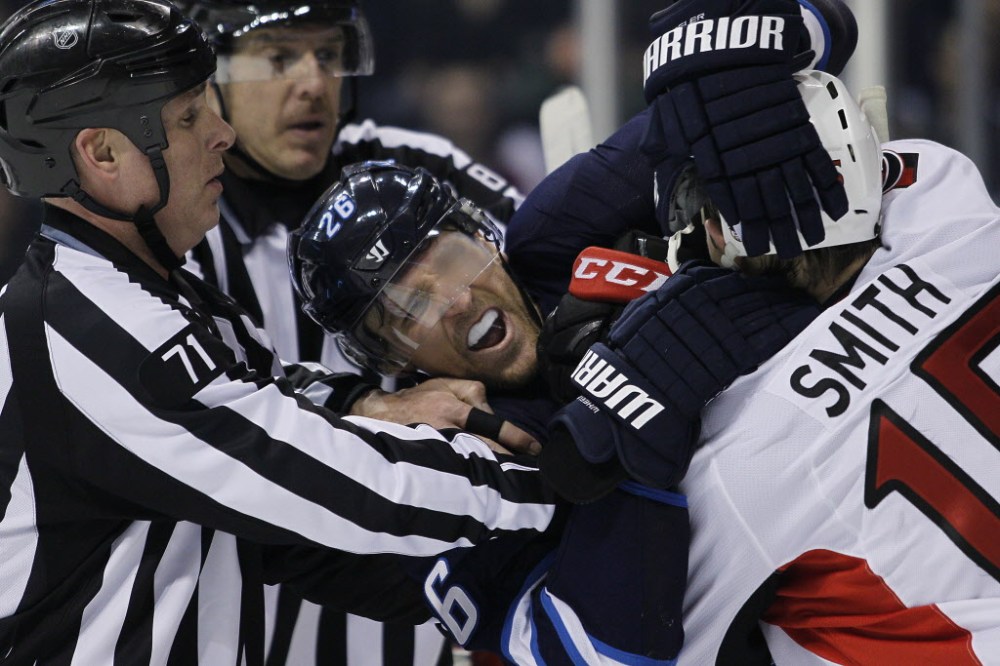 John Woods / THE CANADIAN PRESS
Referees attempt to pull apart Winnipeg Jets' Blake Wheeler (26) and Ottawa Senators' Zack Smith (15) during second period NHL action in Winnipeg on Saturday, March 8, 2014.