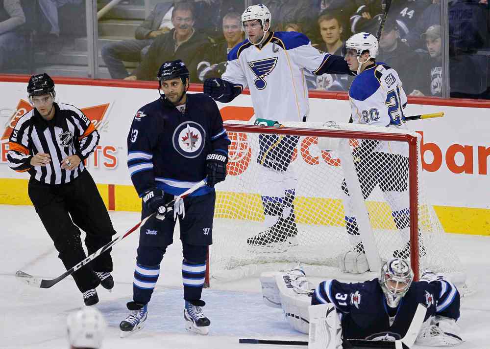 JOHN WOODS / THE CANADIAN PRESS
St. Louis Blues' David Backes (centre) and Alexander Steen (top right) celebrate Backes's first-period goal as Dustin Byfuglien looks away.