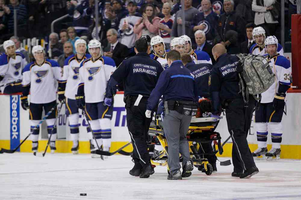 JOHN WOODS / THE CANADIAN PRESS
Jacob Trouba is taken off the ice by paramedics.
