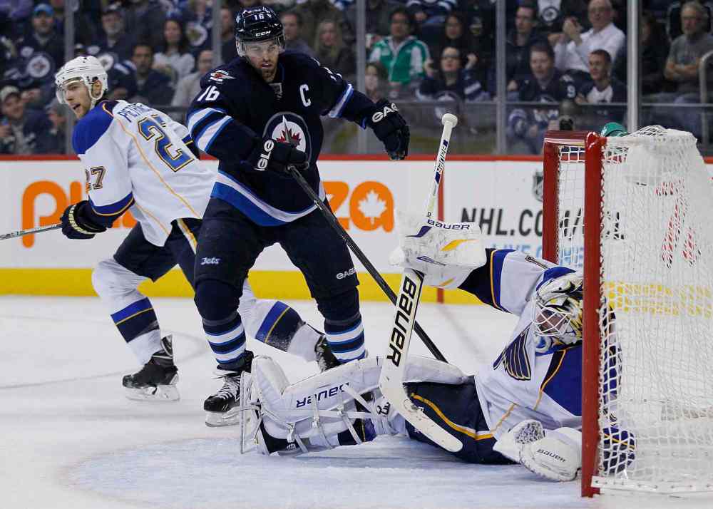 JOHN WOODS / THE CANADIAN PRESS
St. Louis Blues goaltender Brian Elliott gets tangled in Andrew Ladd's stick during the second period.