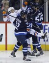 John Woods / THE CANADIAN PRESS
Edmonton Oilers forward Benoit Pouliot (67) gets sandwiched between Winnipeg Jets forward Scott Kosmachuk (72) and forward Adam Lowry (56) during first period NHL pre-season action in Winnipeg on Wednesday.