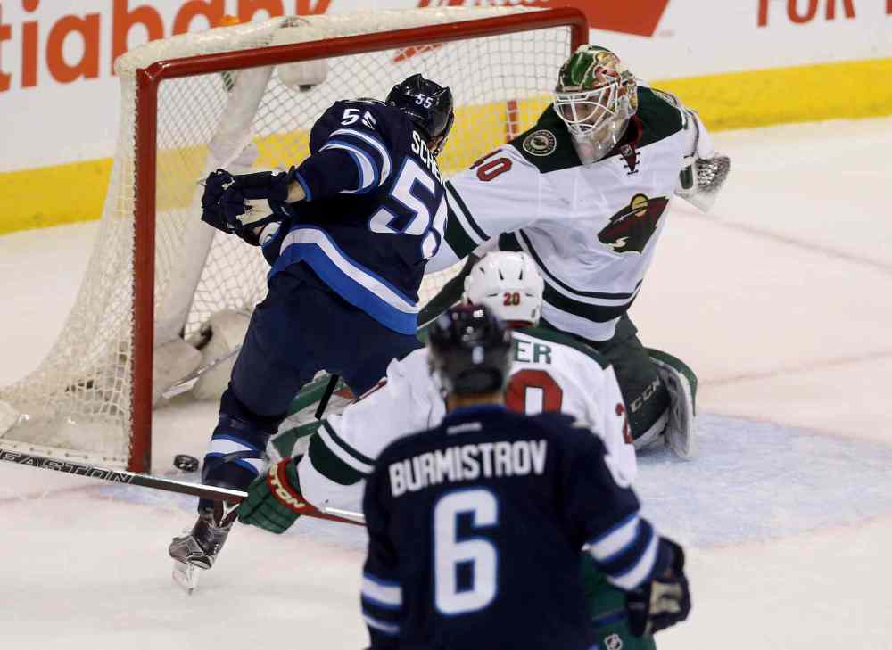 Trevor Hagan / Winnipeg Free Press
Winnipeg Jets' Mark Scheifele (55) scores on Minnesota Wild's goaltender Devan Dubnyk (40) during the first period of Sunday's game.
