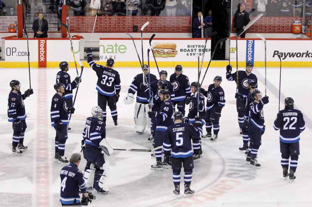 Trevor Hagan / Winnipeg Free Press
The Winnipeg Jets salute the fans following their victory over the Minnesota Wild after their final home game of the season Sunday.