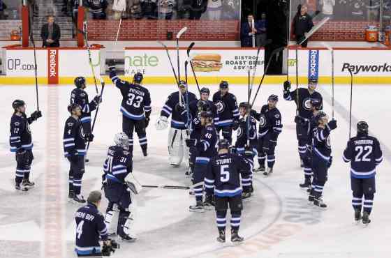Trevor Hagan / Winnipeg Free Press The Winnipeg Jets salute the fans following their victory over the Minnesota Wild after their final home game of the season Sunday.