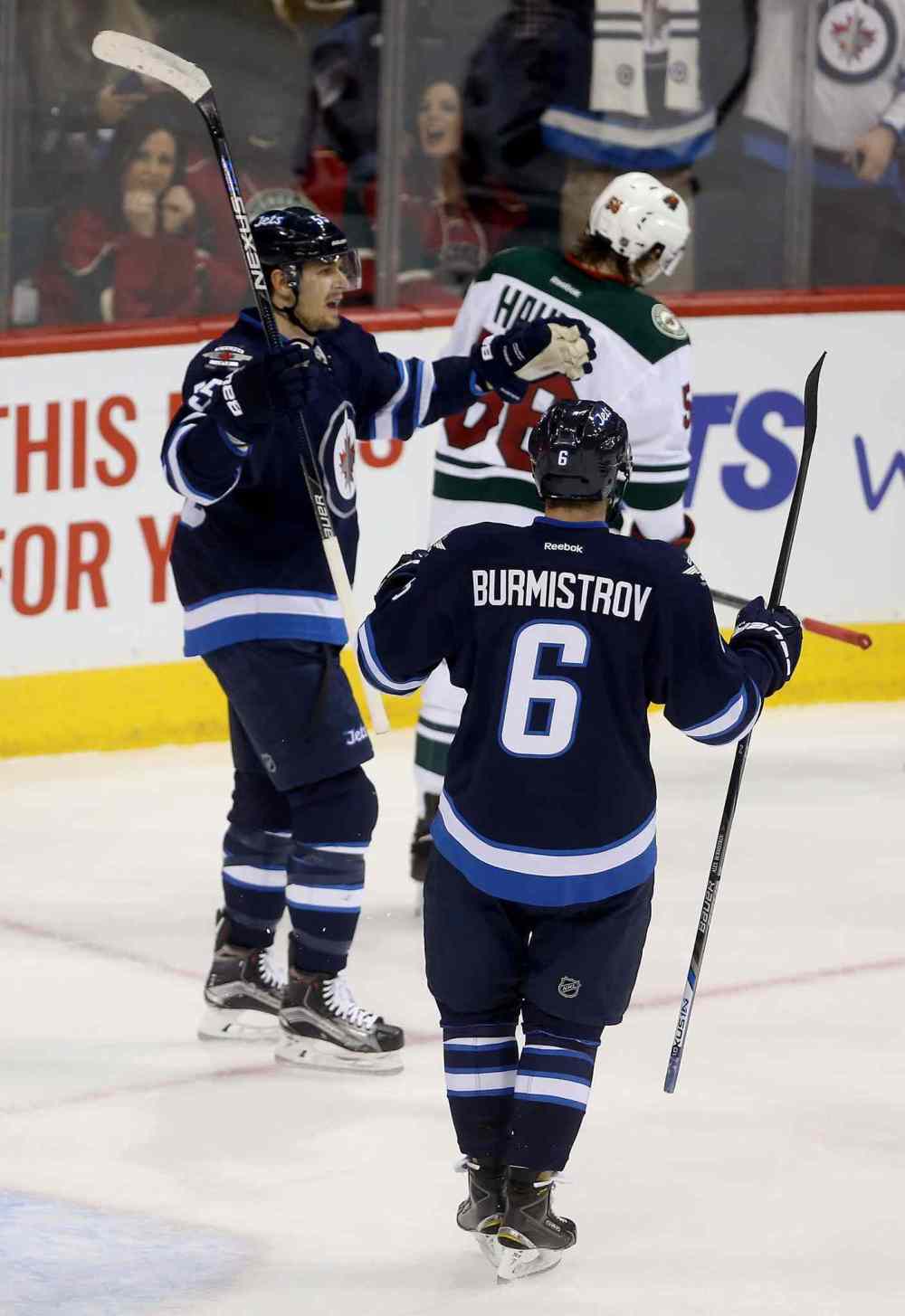 Trevor Hagan / The Canadian Press
Winnipeg Jets' Mark Scheifele (55) celebrates with Alexander Burmistrov (6) after scoring on the Minnesota Wild.