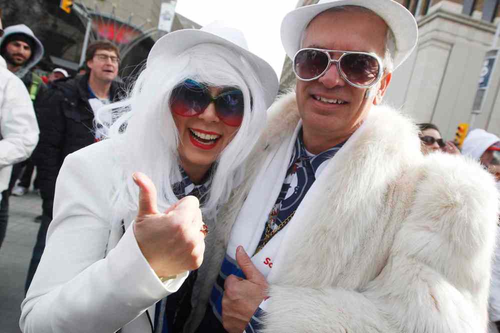 JOHN WOODS / THE CANADIAN PRESS
Linda Van Den Broek and Jeff Seaford get in the playoff spirit at the Winnipeg Jets White Out Street Party prior to game one of the playoff series against Minnesota Wild Wednesday, April 11, 2018.