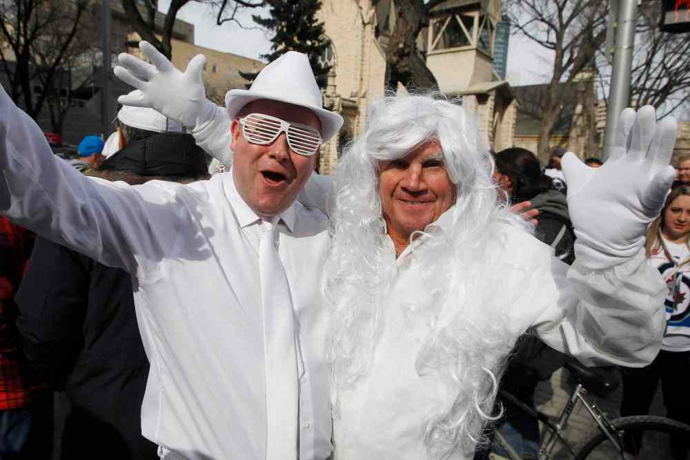 JOHN WOODS / THE CANADIAN PRESS
Joshua and Stan Plett get in the playoff spirit at the Winnipeg Jets White Out Street Party prior to game one of the playoff series against Minnesota Wild Wednesday, April 11, 2018.