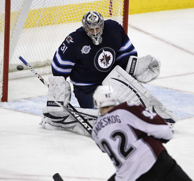 Trevor Hagan / The Canadian Press
Colorado Avalanche's Gabriel Landeskog (92) puts the puck past Winnipeg Jets' goaltender Ondrej Pavelec (31).