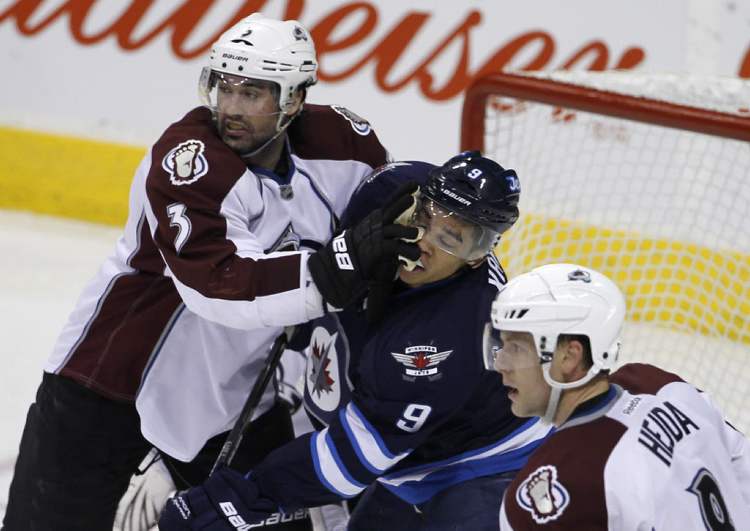 Trevor Hagan / The Canadian Press
Colorado Avalanche's Ryan O'Bryne (3) puts a glove in the face of Winnipeg Jets' Evander Kane (9) in front of the Colorado net.