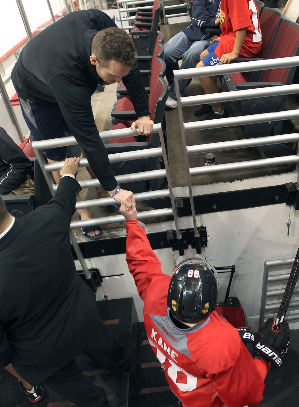 Jets Captain Andrew Ladd, top, shakes hands with Chicago Blackhawks Patrick Kane at the morning skate. (JOE BRYKSA / WINNIPEG FREE PRESS)