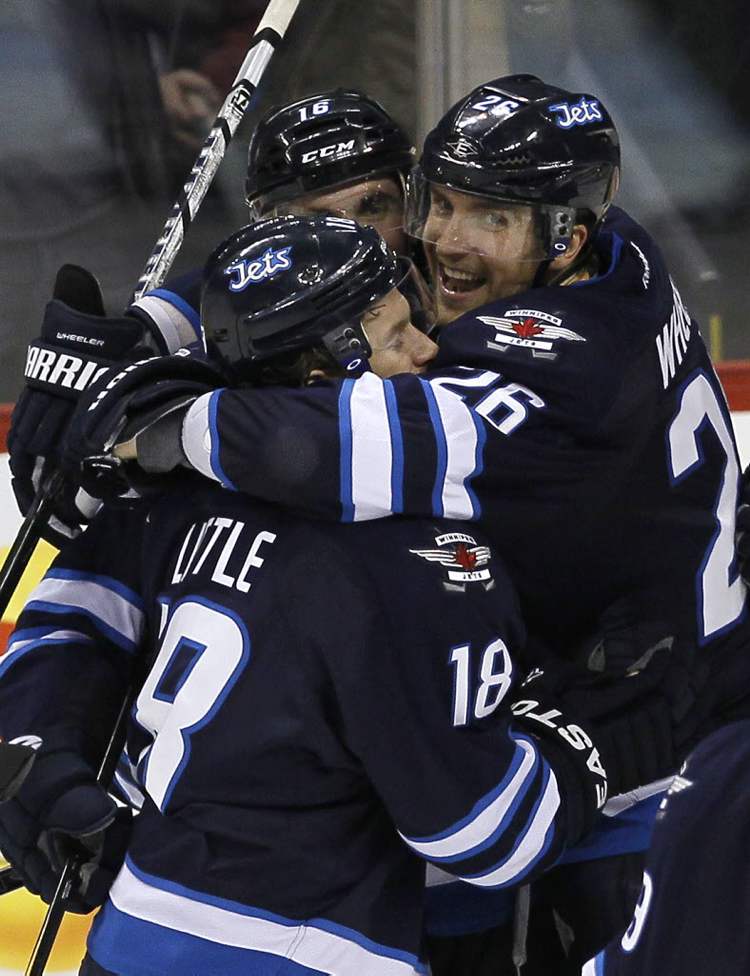 John Woods / The Winnipeg Free Press
Winnipeg Jets' Andrew Ladd (16), Bryan Little (18), and Blake Wheeler (26), celebrate Ladd's goal.