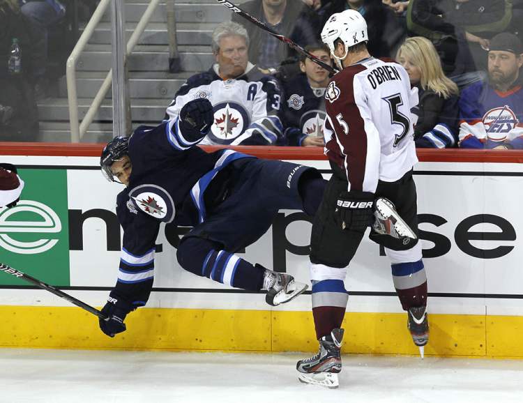 John Woods / The Winnipeg Free Press
Winnipeg Jets' Evander Kane (9) gets flattened by Colorado Avalanche's Shane O'Brien (5).