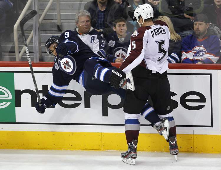 John Woods / The Winnipeg Free Press
Winnipeg Jets' Evander Kane (9) gets flattened by Colorado Avalanche's Shane O'Brien (5) during the third period.