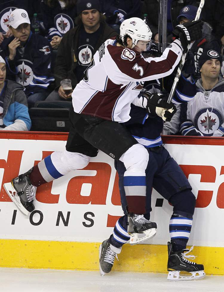 John Woods / Winnipeg Free Press
Winnipeg Jets' Andrew Ladd (16) is checked hard by Colorado Avalanche's Ryan O'Bryne (3) during the first period.