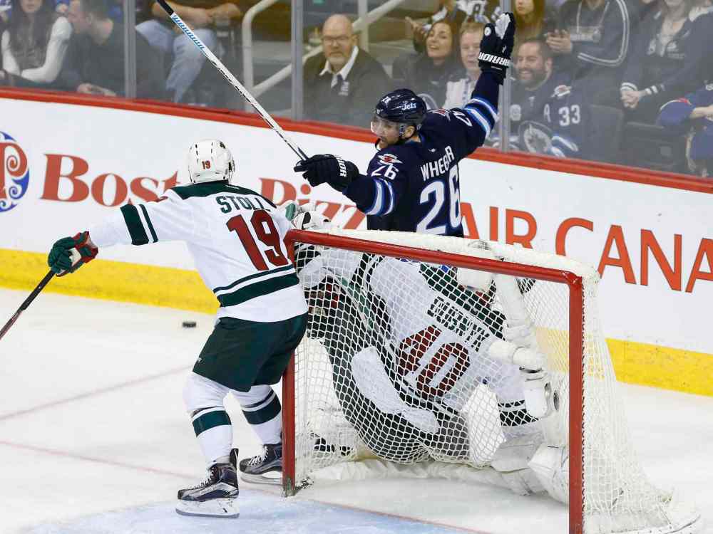 JOHN WOODS / WINNIPEG FREE PRESS
Winnipeg Jets' Blake Wheeler (26) knocks Minnesota Wild's goaltender Devan Dubnyk (40) into the net as Jarret Stoll (19) defends during third period NHL action in Winnipeg on Sunday, April 3, 2016. Wheeler got a two-minute minor for interference.