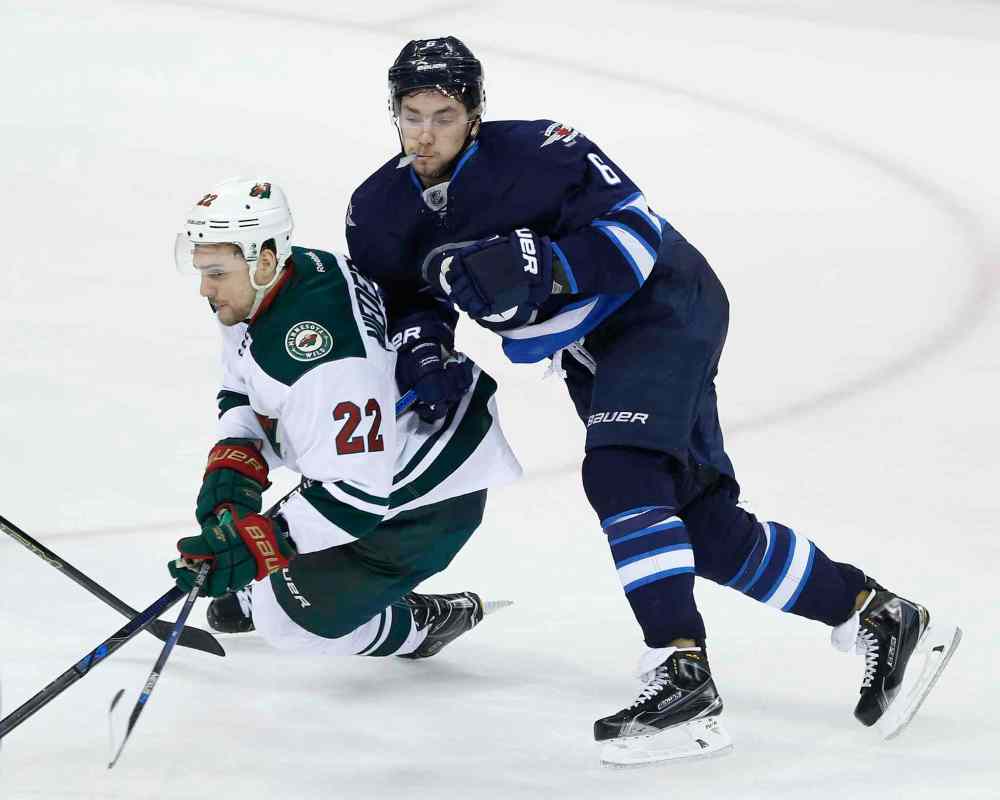 JOHN WOODS / WINNIPEG FREE PRESS
Winnipeg Jets' Jacob Trouba (8) checks Minnesota Wild's Nino Niederreiter (22) during third period.