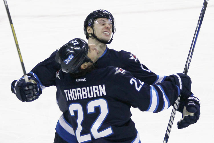 JOHN WOODS / THE CANADIAN PRESS
Winnipeg Jets' James Wright and Chris Thorburn (22) celebrate Wright's goal against the Montreal Canadiens during the first period.