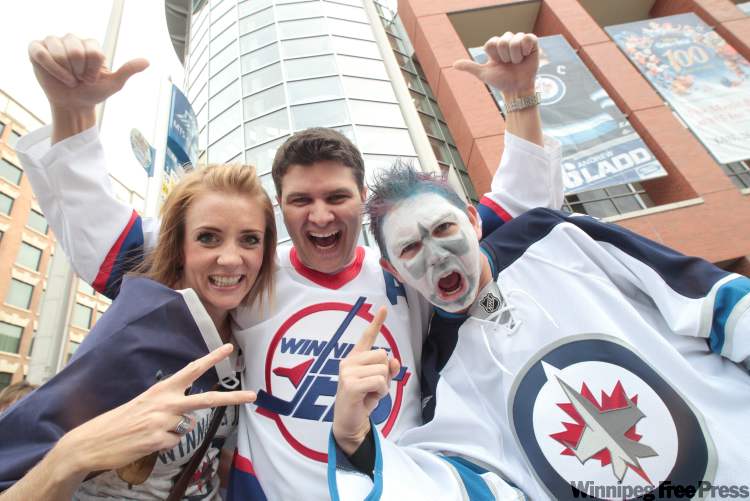 Britt Billson, left, Kyle Mackay and Eric Hogue, right, outside the MTS Centre. (Mike Deal / Winnipeg Free Press)