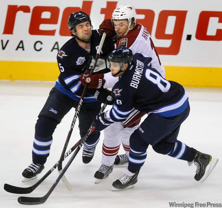Phil Hossack / Winnipeg Free Press
Jet Mark Stuart (5) collides with Coyote Martin Hanzal while Alexander Burmistrov follows the play Thursday at the MTS Centre.
