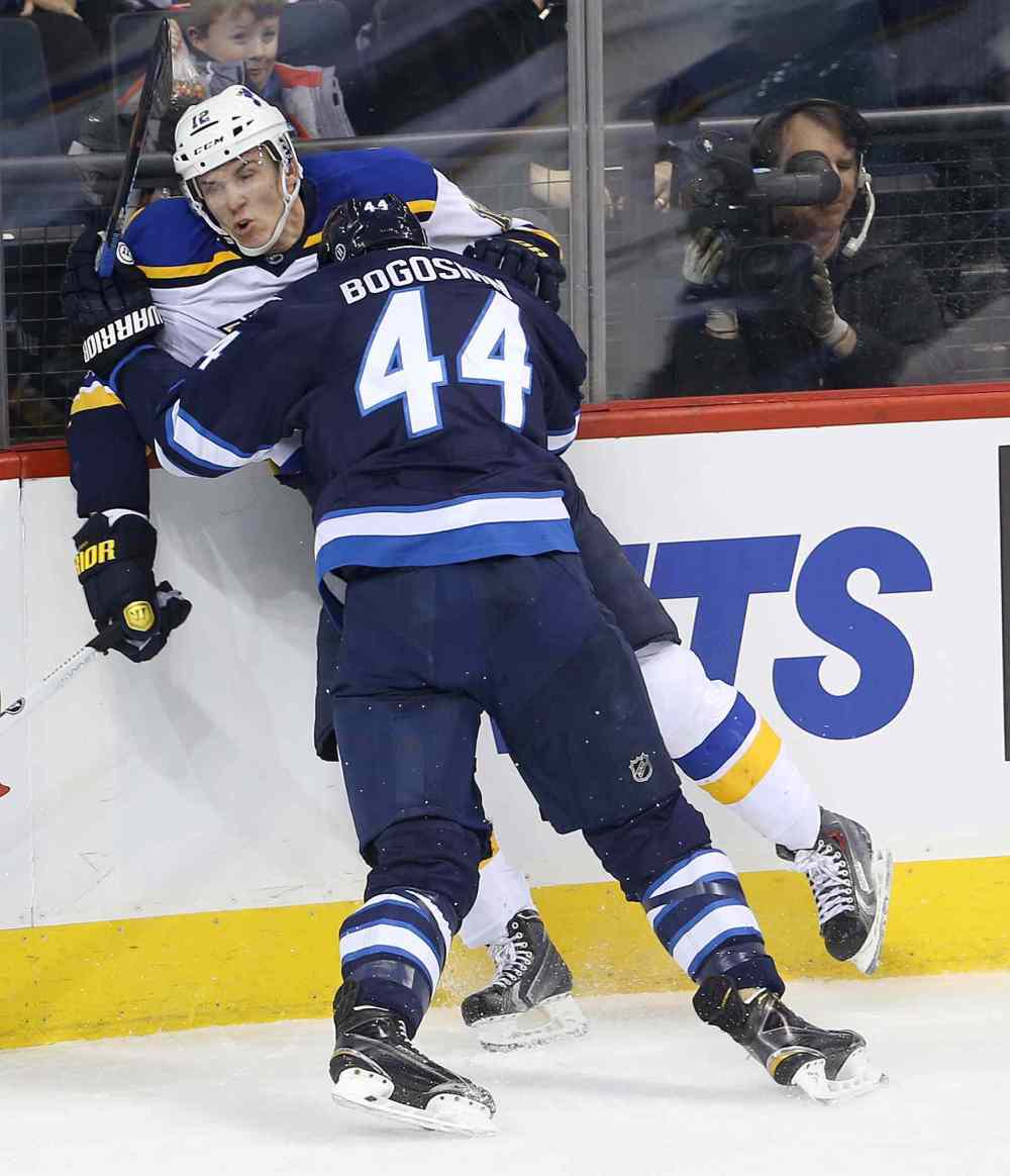 TREVOR HAGAN / WINNIPEG FREE PRESS
Jets defenceman Zach Bogosian staples the St. Louis Blues' Jori Lehtera into the boards during the first period.