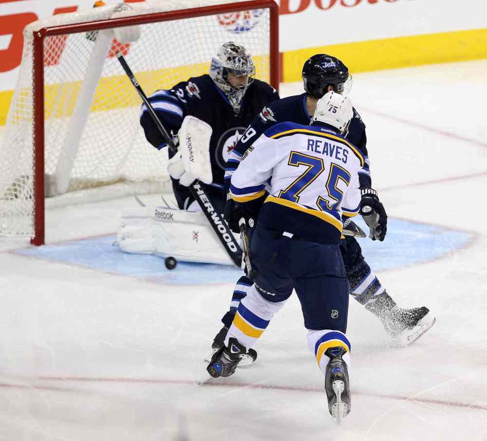 TREVOR HAGAN / WINNIPEG FREE PRESS
Blues forward Ryan Reaves (75) fires the puck past Jets goaltender Ondrej Pavelec during third-period NHL action.