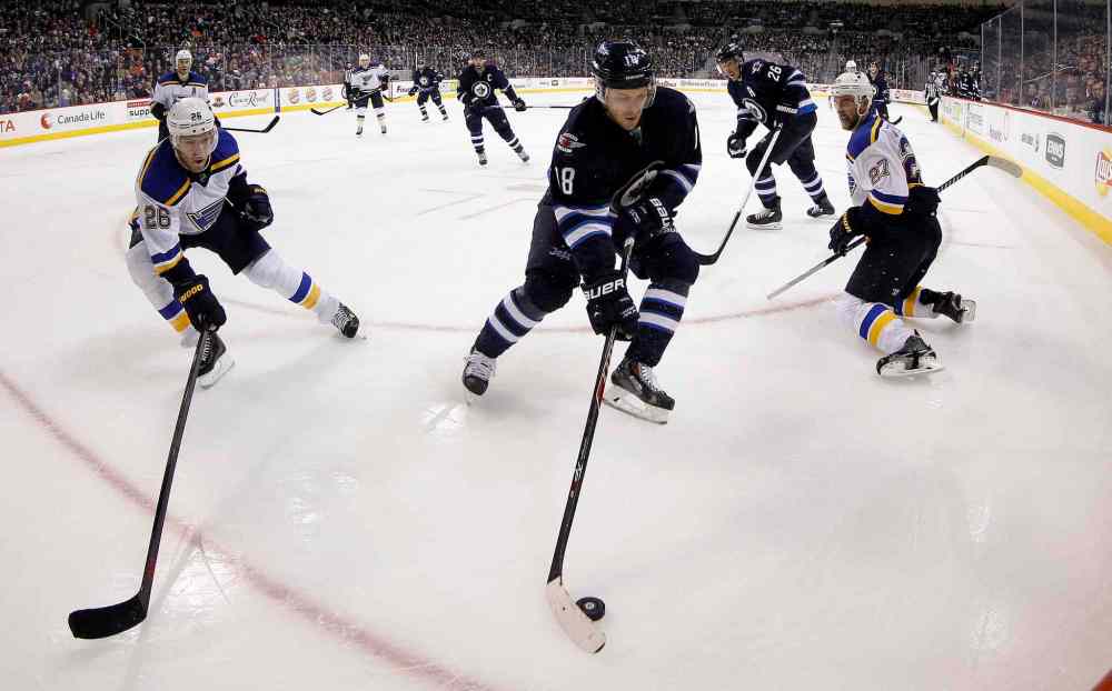 TREVOR HAGAN / WINNIPEG FREE PRESS
The Jets' Bryan Little handles the puck between St. Louis's Paul Stastny (26) and Alex Pietrangelo (27) during the second period.