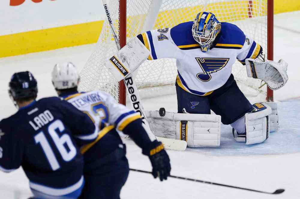 JOHN WOODS / THE CANADIAN PRESS
Jake Allen stops the shot from Jets captain Andrew Ladd as the Blues' Kevin Shattenkirk defends during the first period.