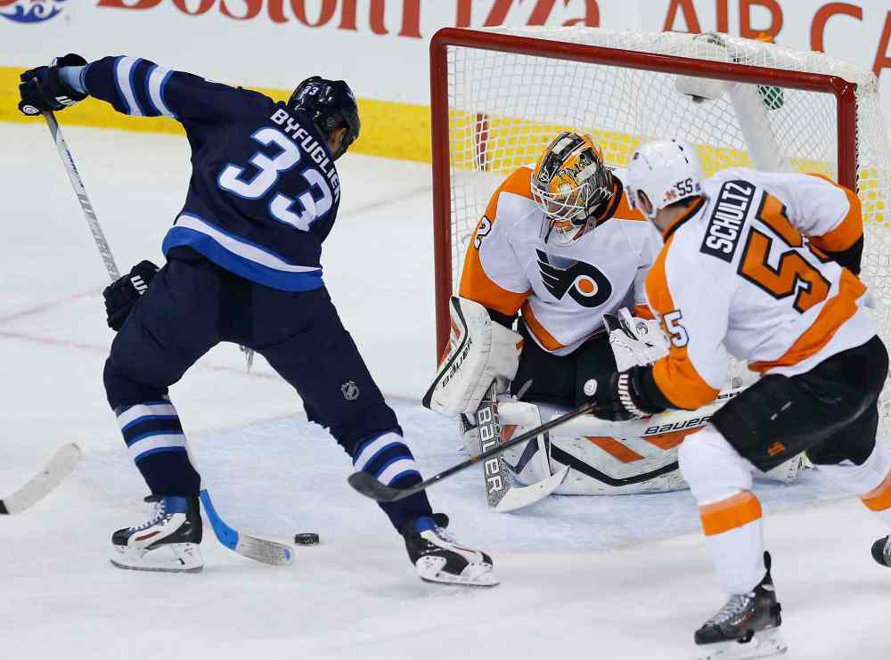JOHN WOODS / WINNIPEG FREE PRESS
Winnipeg's Dustin Byfuglien scores on Philadelphia's Rob Zepp as Nick Schultz defends during the first period NHL.