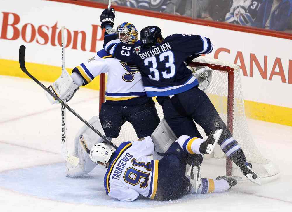 TREVOR HAGAN / WINNIPEG FREE PRESS
Winnipeg Jets power forward Dustin Byfuglien and the St. Louis Blues' Vladimir Tarasenko crash into Blues goalie Jake Allen during third-period NHL action at the MTS Centre Sunday.
