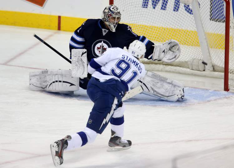 Trevor Hagan / THE CANADIAN PRESS
Tampa Bay Lightning sniper Steven Stamkos misses the net as Winnipeg Jets goaltender Ondrej Pavelec sprawls to try to stop the puck during first-period NHL action in Winnipeg, Sunday.