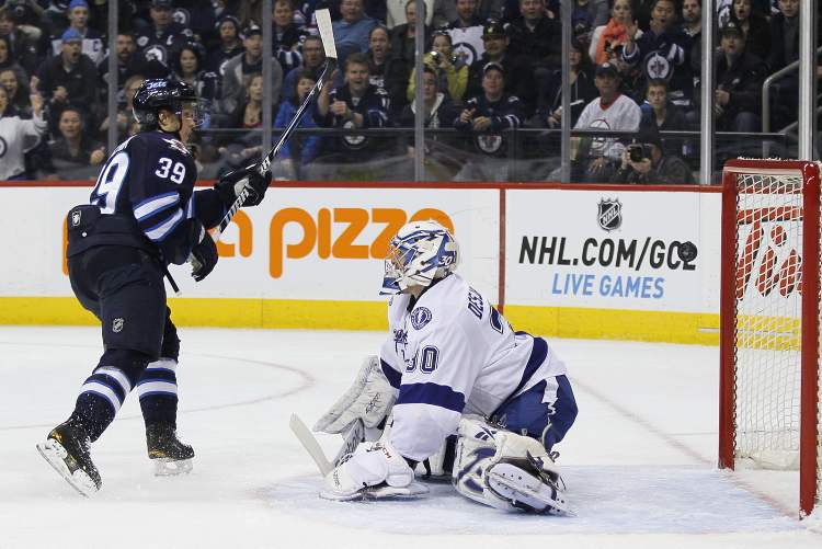 JOHN WOODS / WINNIPEG FREE PRESS
Winnipeg Jets defenceman Tobias Enstrom scores on Tampa Bay Lightning goaltender Cedrick Desjardins during second-period NHL action in Winnipeg on Sunday. The goal proved to be the game-winner.