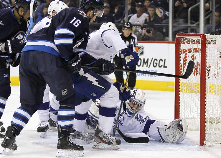 JOHN WOODS / WINNIPEG FREE PRESS
Tampa Bay Lightning goaltender Cedrick Desjardins stops a shot from Winnipeg Jets' Andrew Ladd (16) during the second period of an NHL game in Winnipeg on Sunday.