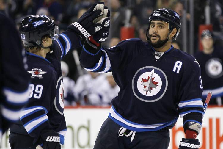 JOHN WOODS / WINNIPEG FREE PRESS
Winnipeg Jets defencemen Dustin Byfuglien (right) and Tobias Enstrom celebrate Byfuglien's goal against the Tampa Bay Lightning during second-period NHL action in Winnipeg on Sunday.