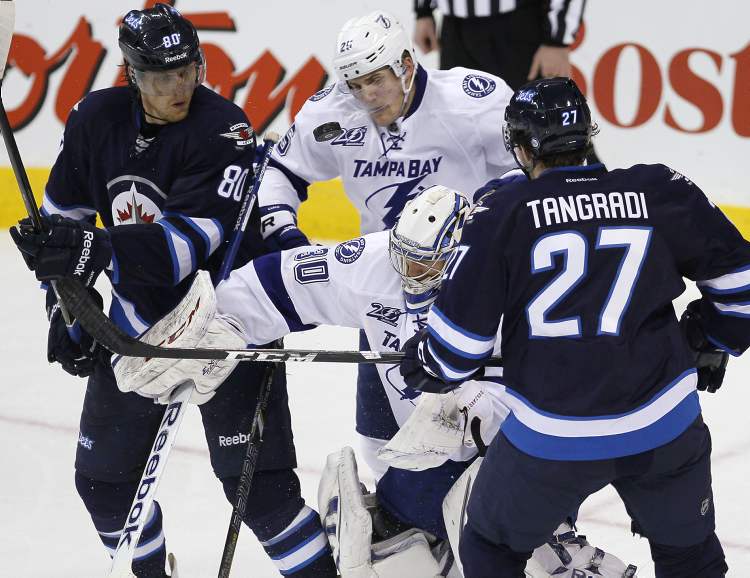 JOHN WOODS / WINNIPEG FREE PRESS
Winnipeg Jets' Nik Antropov (80) and Eric Tangradi and Tampa Bay Lightning's Matthew Carle look for the rebound off of Lightning goaltender Cedrick Desjardins during third-period NHL action in Winnipeg on Sunday.