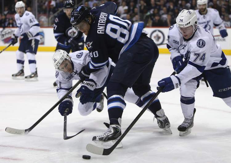 Trevor Hagan / THE CANADIAN PRESS
Winnipeg Jets' Nik Antropov battles for the puck between Tampa Bay Lightnings' Tom Pyatt (left) and Ondrej Palat during the second period pf an NHL game in Winnipeg, Sunday.