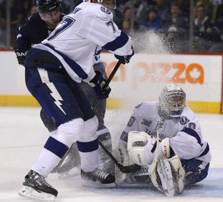 Trevor Hagan / THE CANADIAN PRESS
Tampa Bay Lightning goaltender Cedrick Desjardins gets a face full of snow as Winnipeg Jets' Andrew Ladd and Lightnings' Victor Hedman crash the net during the second in Winnipeg, Sunday.