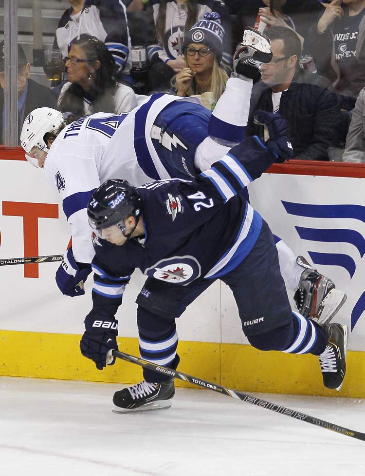 JOHN WOODS / WINNIPEG FREE PRESS
Winnipeg Jets' Grant Clitsome (24) checks Tampa Bay Lightning's Nate Thompson during first-period NHL action in Winnipeg on Sunday.