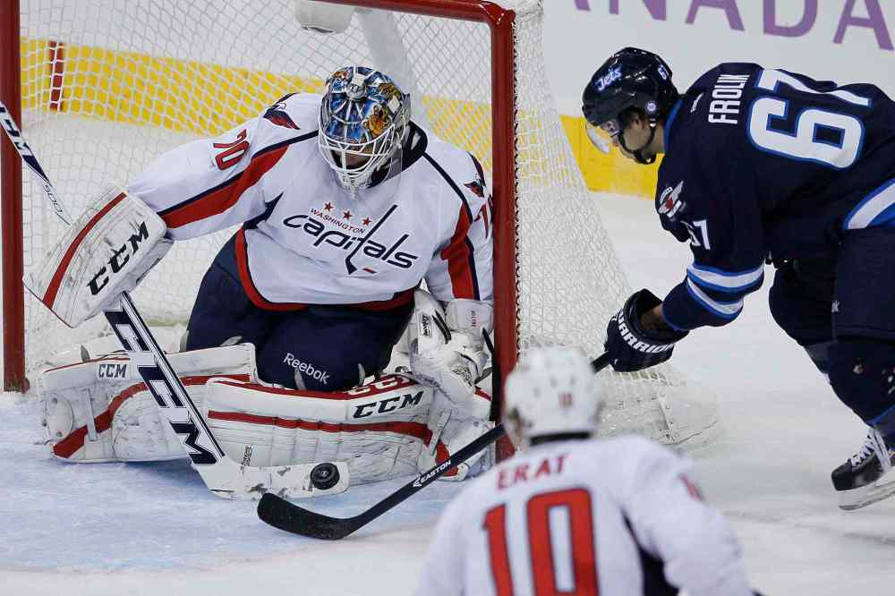 JOHN WOODS / WINNIPEG FREE PRESS
Washington Capitals goaltender Braden Holtby makes a save on a close-in scoring chance by Winnipeg Jets forward Michael Frolik during first-period NHL action at the MTS Centre in Winnipeg Tuesday.