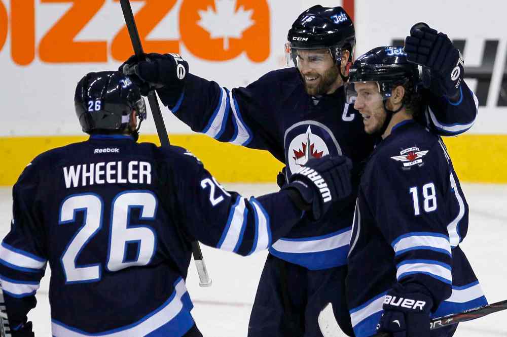 JOHN WOODS / WINNIPEG FREE PRESS
Winnipeg Jets' Blake Wheeler, Andrew Ladd and Bryan Little (18) celebrate Ladd's goal against the Anaheim Ducks during first-period NHL action at the MTS Centre in Winnipeg, Sunday.