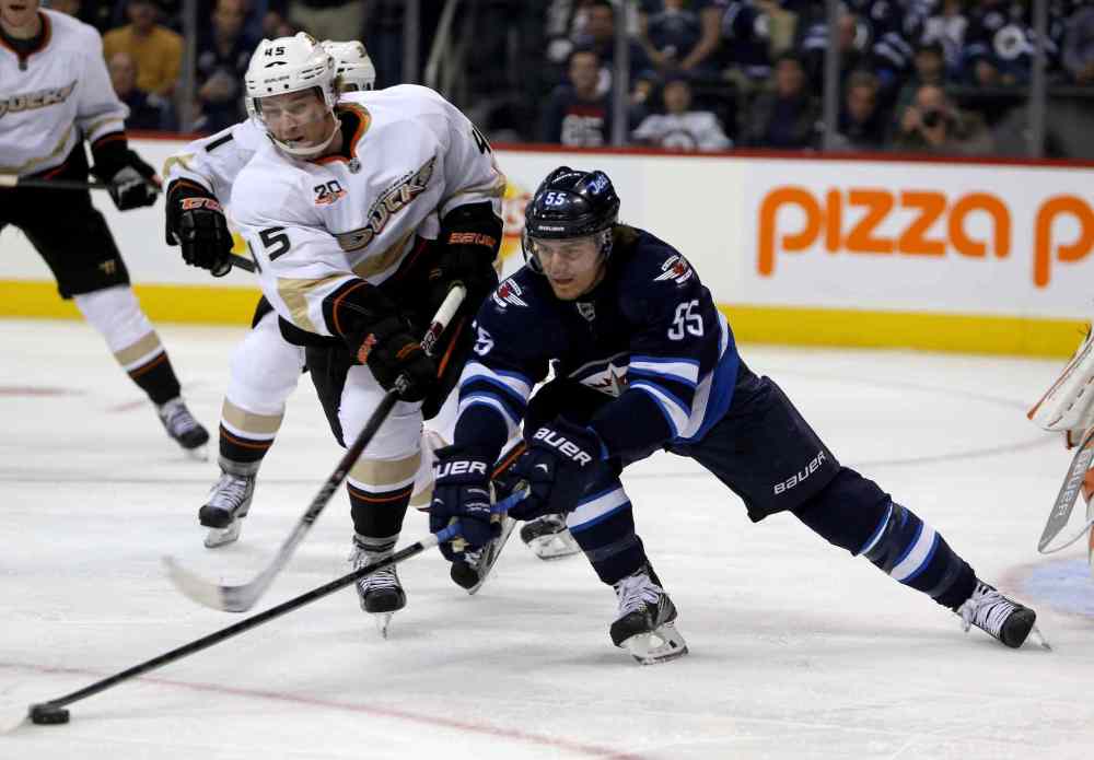 TREVOR HAGAN / THE CANADIAN PRESS
Anaheim Ducks' Sami Vatanen battles with Winnipeg Jets' Mark Scheifele in the second period.