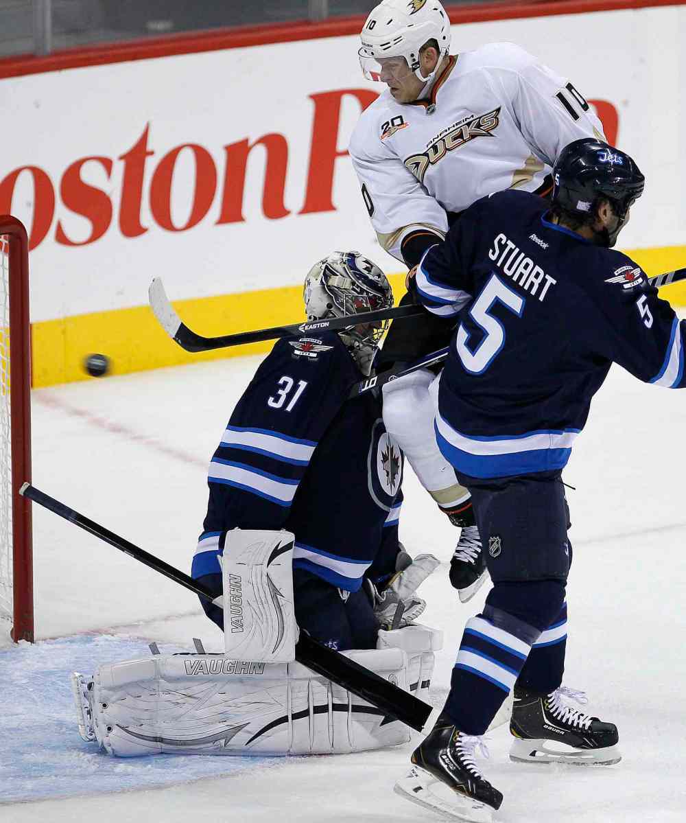 JOHN WOODS / WINNIPEG FREE PRESS
Anaheim Ducks' Corey Perry watches his deflection go wide behind Jets' goaltender Ondrej Pavelec and Mark Stuart during the first period.