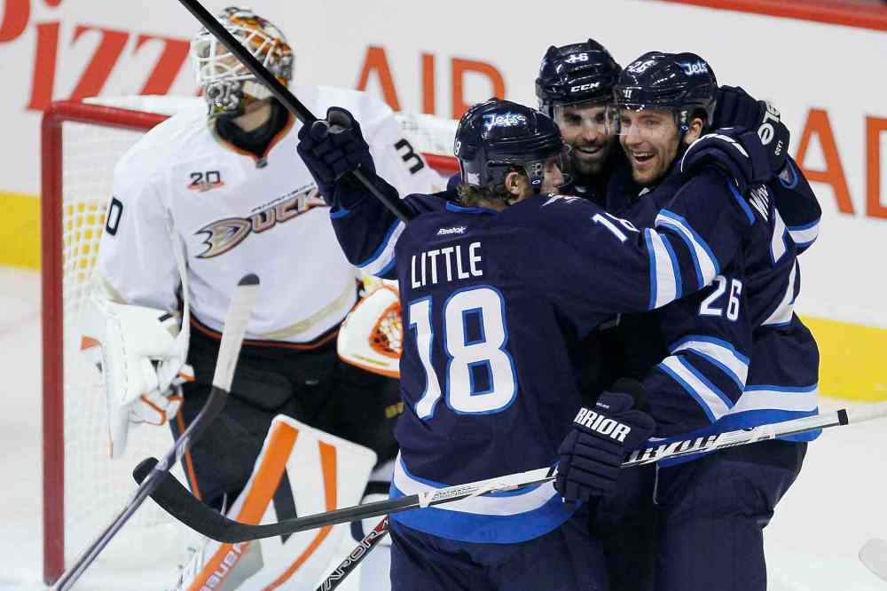 JOHN WOODS / WINNIPEG FREE PRESS
Winnipeg Jets' Bryan Little, Andrew Ladd and Blake Wheeler celebrate Ladd's goal against Anaheim Ducks' goaltender Viktor Fasth during the first period.