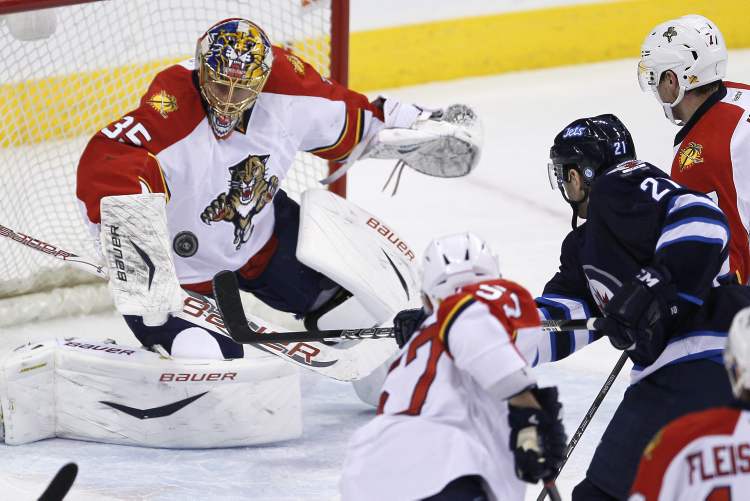 JOHN WOODS / THE CANADIAN PRESS
Florida Panthers goaltender Jacob Markstrom stops the shot from Winnipeg Jets' Aaron Gagnon as Panthers' Marcel Goc (57) and Dmitry Kulikov (7) look for a rebound during first-period NHL action in Winnipeg Thursday.