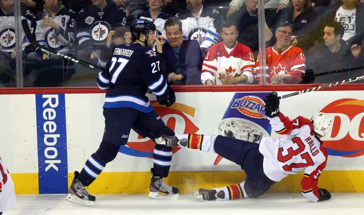 Phil Hossack / Winnipeg Free Press
Winnipeg Jets' Eric Tangradi takes Florida Panthers' Greg Rallo out of the play as fans react behind the glass in the third period Thursday.