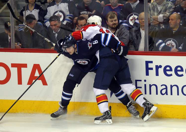 Phil Hossack / Winnipeg Free Press
Winnipeg Jets defenceman Ron Hainsey takes Florida Panthers' Jack Skille out of the play in the third period Thursday.