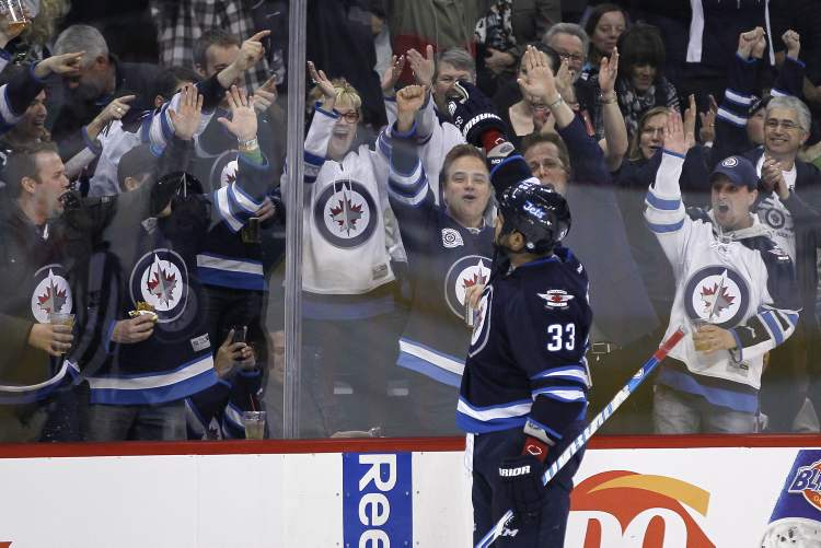 JOHN WOODS / THE CANADIAN PRESS
Winnipeg Jets defenceman Dustin Byfuglien salutes the fans after scoring against the Florida Panthers during second-period NHL action in Winnipeg Thursday,.
