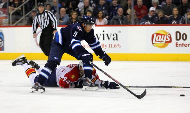 Phil Hossack / Winnipeg Free Press
Winnipeg Jets forward Evander Kane skates over a fallen Erik Gudbranson in the second period to score his second goal against the Florida Panthers.