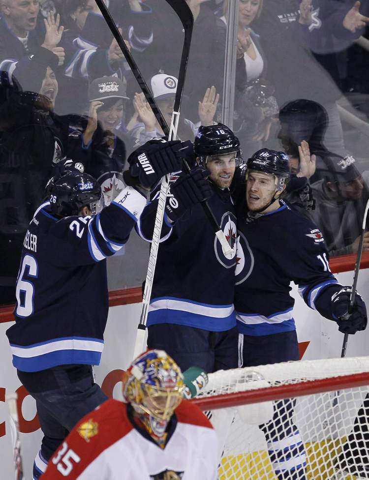 JOHN WOODS / THE CANADIAN PRESS
Winnipeg Jets Andrew Ladd (16), Bryan Little (18) and Blake Wheeler (26) celebrate Ladd's goal against the Florida Panthers during first-period NHL action in Winnipeg Thursday.